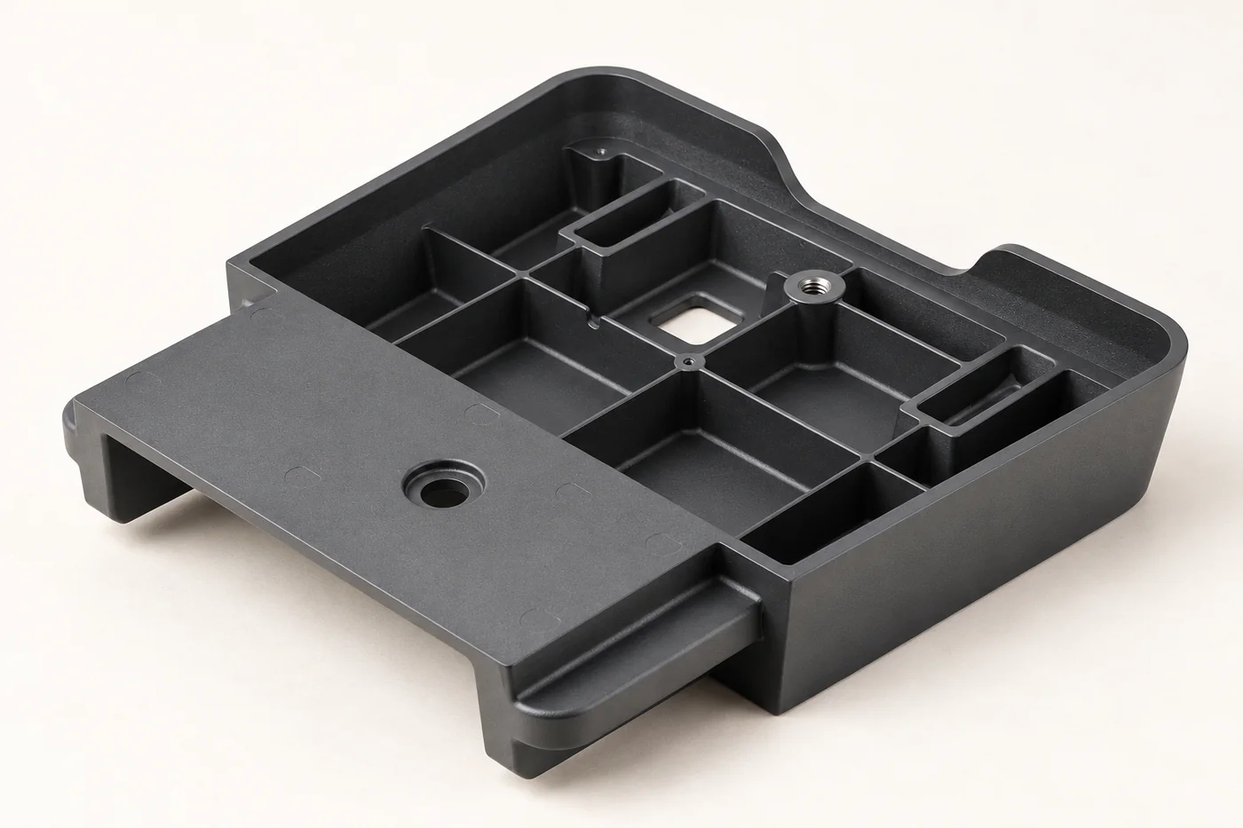 Dark rectangular enclosure tray with ribs, bosses and mounting extensions
