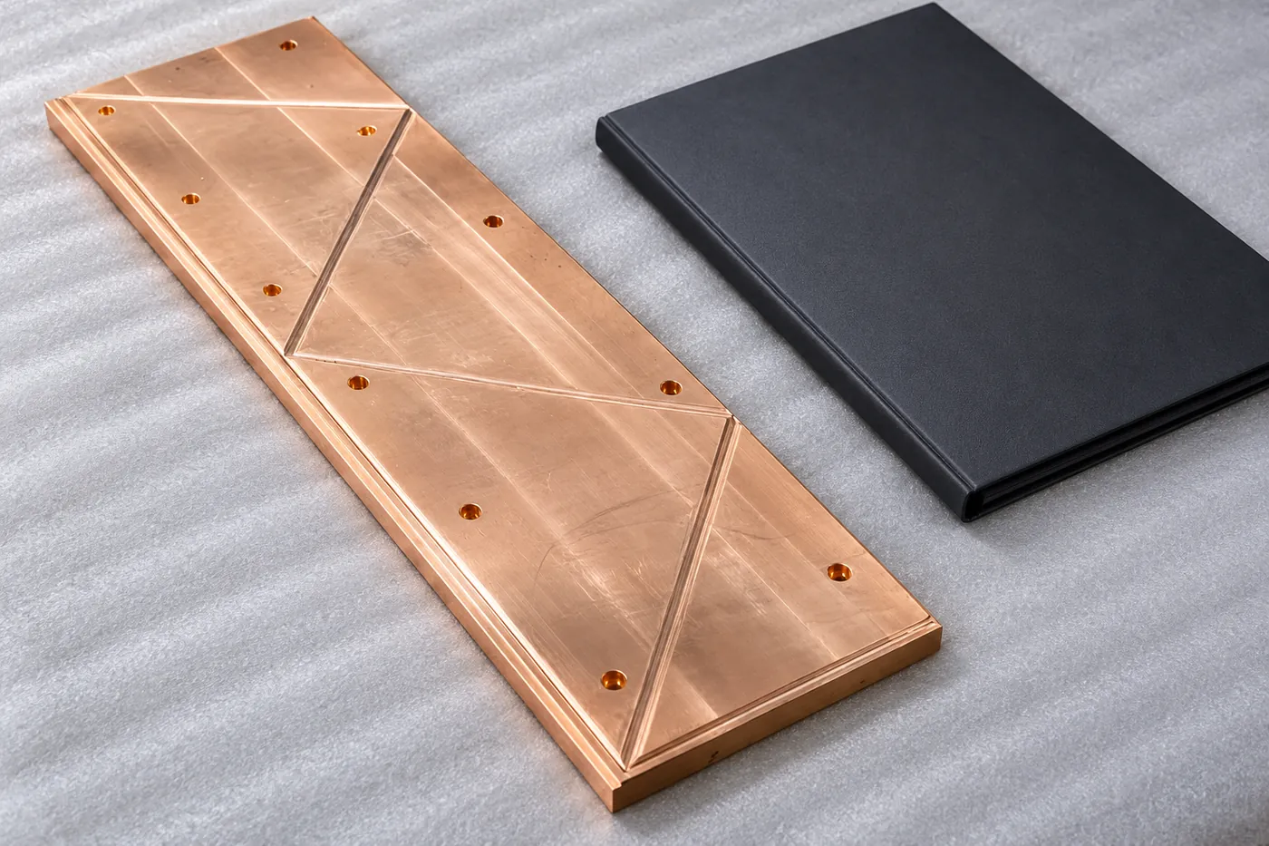 Brass sliding plate protected beside a plain closed folder