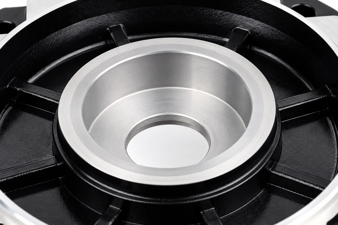 Close detail of the circular bore and silver register in a black end cover