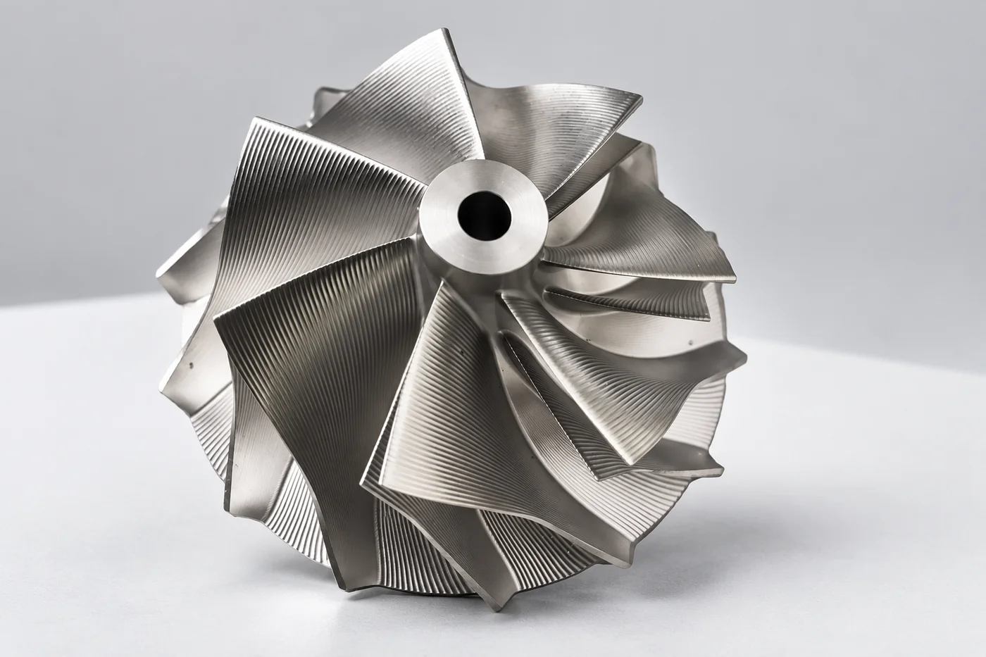 Static industrial turbine impeller reference on a neutral studio plinth