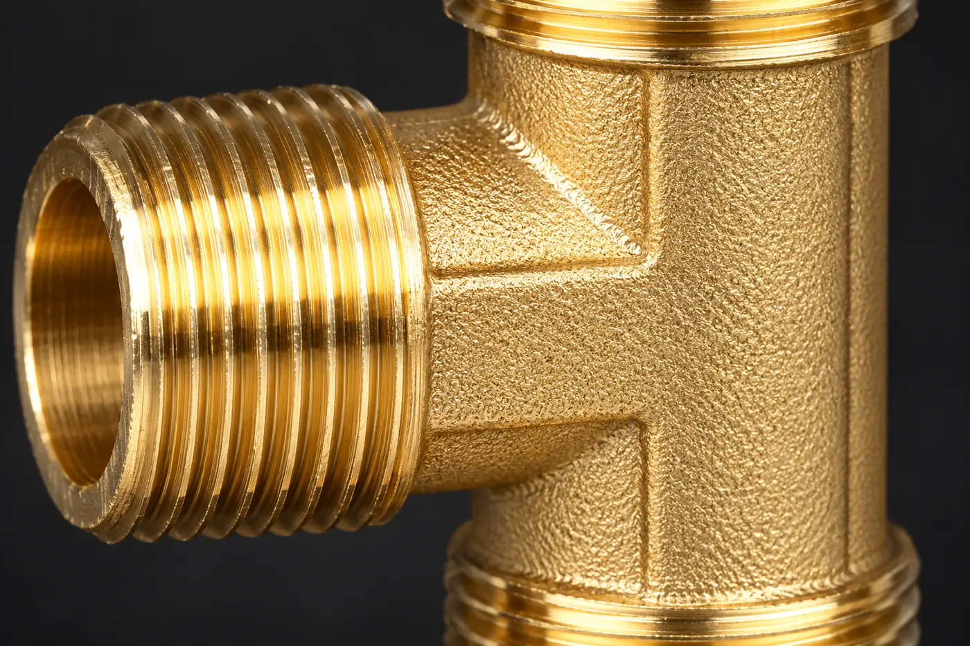 Close detail of a brass threaded branch joining the fitting body