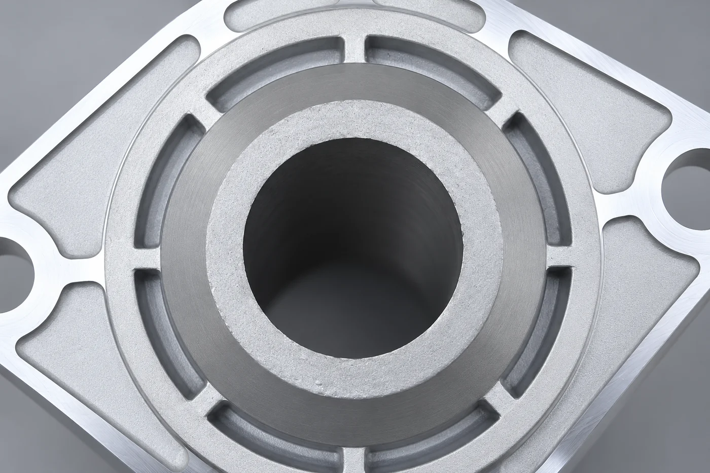Close detail of a circular bore, register and supporting ribs in a motor-cover reference
