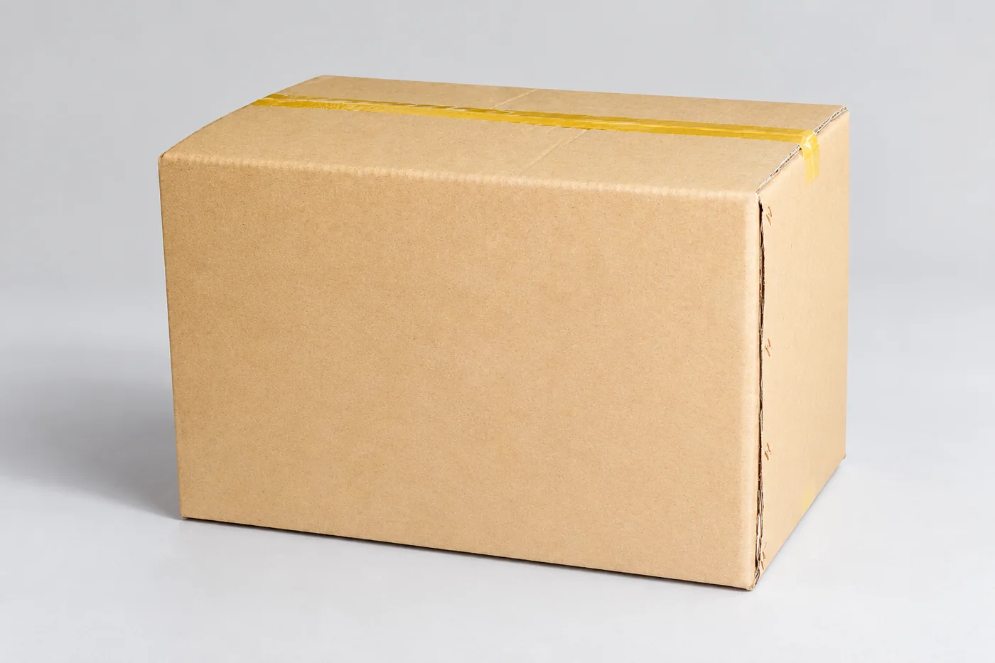 Plain investment-material box on a pale neutral studio plinth