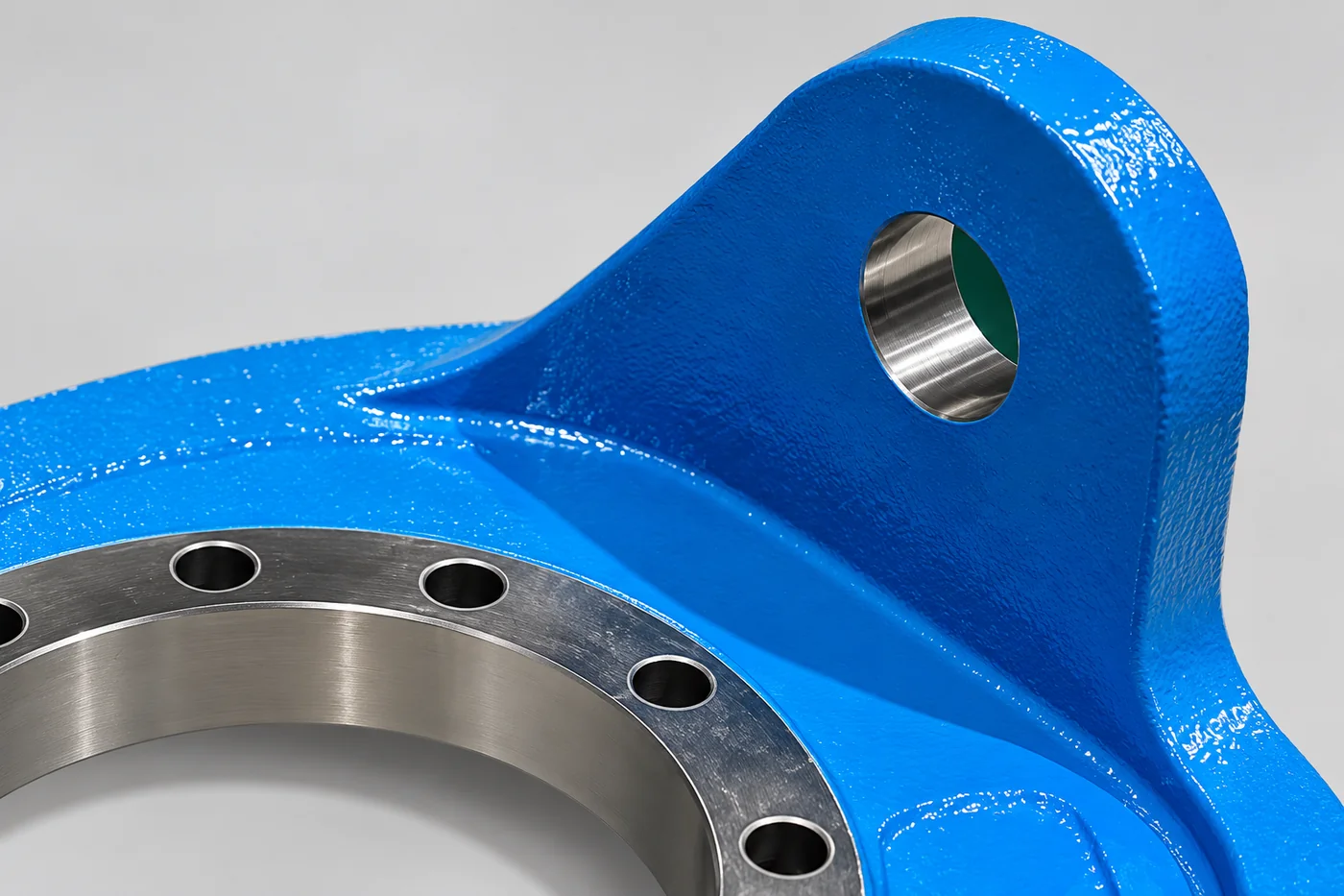 Close view of a mounting ear and machined face on a blue frame