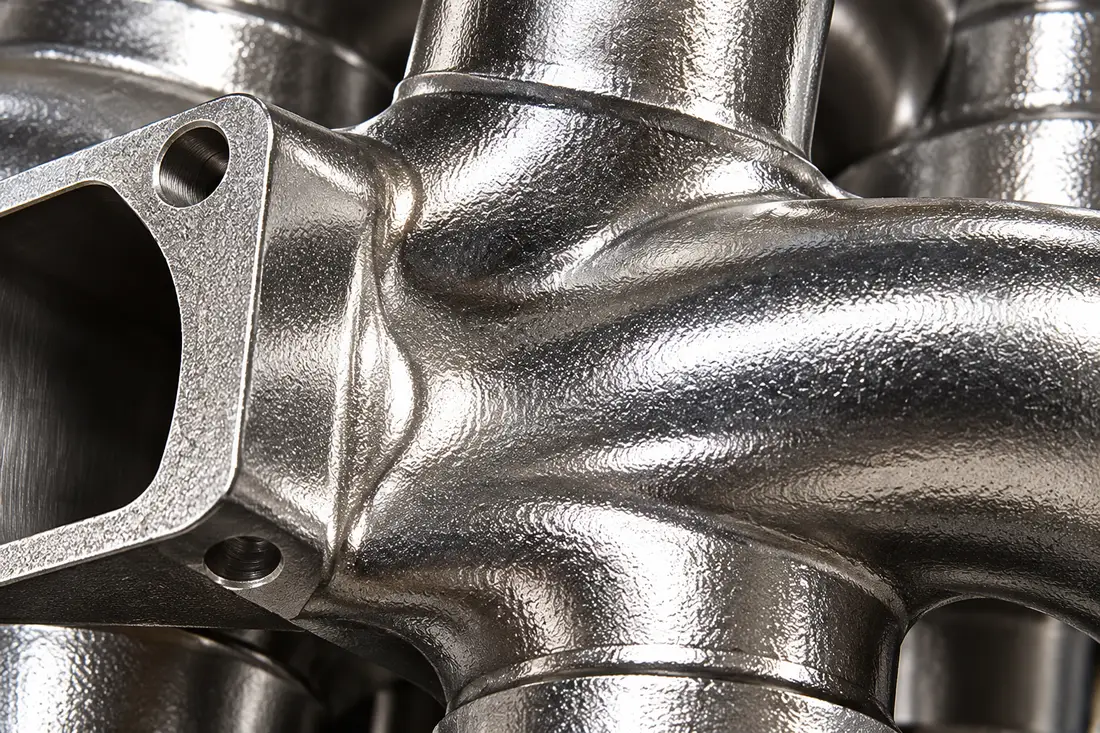 Close detail of a curved cast-pipe branch junction and connection opening